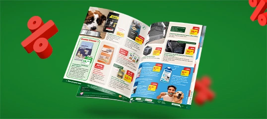 Maxi Zoo promotional leaflet open on deals and discounts, green background with red 3D percentage symbols.