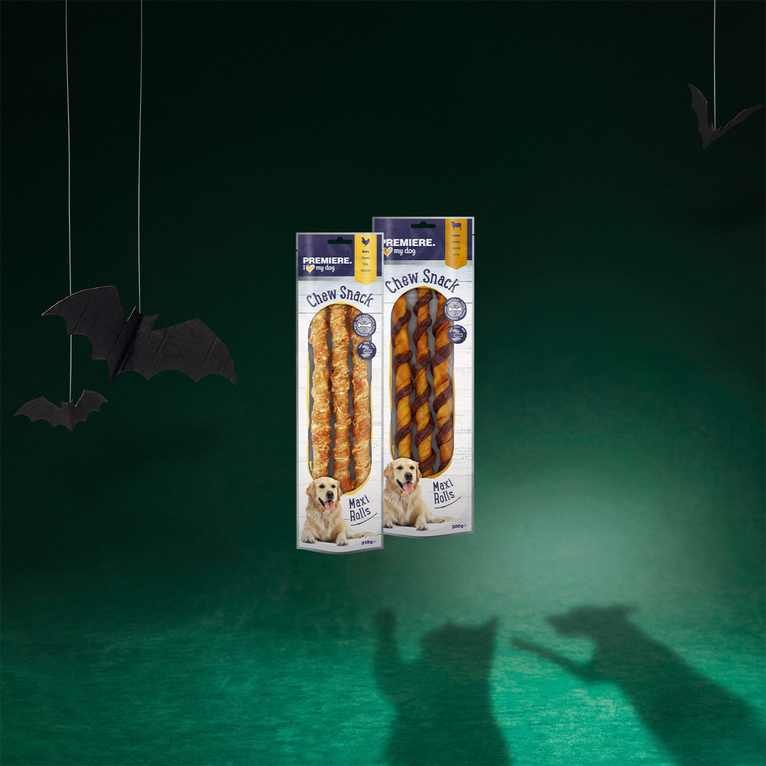 L'image représente deux paquets de friandises pour chien de la marque PREMIERE, dans les variétés « Rouleau à mâcher poulet » 315 g et « Rouleau à mâcher agneau » 300 g.