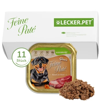 Hundfutterverpackung mit einem lächelnden Rottweiler, beschriftet mit "Gino's Feine Paté, Reich an Rind," mit 11 Portionen angegeben.