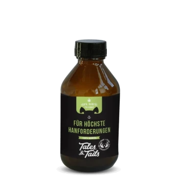 Braune Flasche des Tales & Tails 100% Hanföls für Hunde mit schwarzem Etikett und grünem Text auf Deutsch.