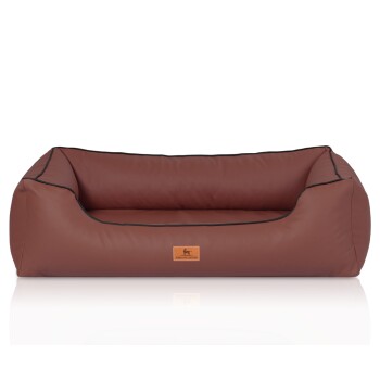 Braunes Hundebett mit schwarzem Rand und einem kleinen Logoanhänger mit der Aufschrift 'KNUFFELWUFF' auf der Vorderseite.