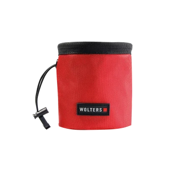 Rotes zylindrisches Hundeleckerli-Beutelchen mit schwarzem Rand, Kordelzug und Frontetikett mit der Aufschrift 'WOLTERS'.