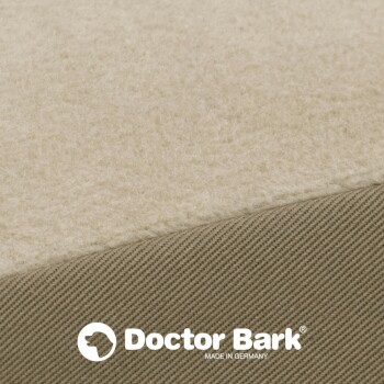 Nahaufnahme eines silbernen Reißverschlusses auf einem beigen Haustierbett, das die Stofftextur und das Reißverschlussdetail zeigt.