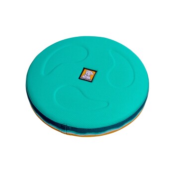 Ein rundes, türkisfarbenes Hundebett mit einer strukturierten Oberfläche und einem schwarzen Ruffwear-Logo in der Mitte.