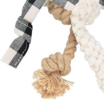 A close-up of a pet toy featuring a braided rope design in natural fibers, with a black and white checkered fabric accent.