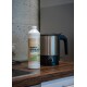 Flasche mit GREEN HERO Floh- und Zecken-Shampoo für Hunde, mit einem lächelnden Hund auf dem Etikett, mit deutschem Text über Schutz und Pflege.