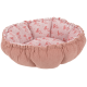 Rundes rosa Cord-Haustierbett mit gerafften Kanten und weichem hellrosa Innenfutter, bedruckt mit kleinen roten Schleifenmotiven.