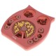 Rosa, eulenförmiges interaktives Hundeleckerli-Puzzle mit Fächern, die knochenförmige Leckerlis und gelbe Paste enthalten.
