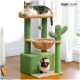 Ein Katzenbaum mit zwei Katzen: einer getigerten, die auf der oberen Plattform liegt, und einer Siamkatze, die aus einer unteren Öffnung schaut, mit grünen und beigen Texturen.
