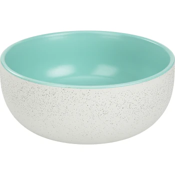 Un bol de nourriture pour animaux de compagnie de couleur claire avec un extérieur blanc tacheté et un intérieur turquoise lisse, présentant un design moderne.