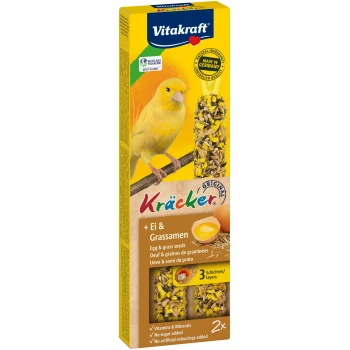 Vitakraft Kräcker bird treat packaging with a yellow canary and text: "Egg & grass seeds," "Vitamins & Minerals," "No sugar added."