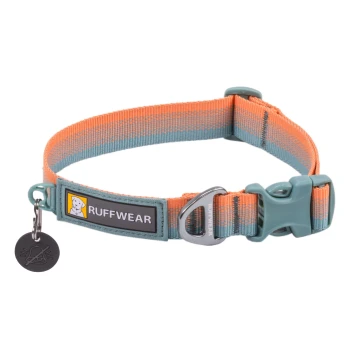 Ein farbenfrohes Hundehalsband von Ruffwear, mit einem blauen und orangefarbenen Design, einem metallenen D-Ring und einem Anhänger mit einem Symbol ohne Glocke.