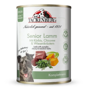 Puszka karmy Tackenberg Senior Lamm dla psów z jagnięciną, dynią, cykorią i łąkowymi ziołami, z wizerunkiem szczęśliwego psa.