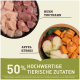 Rohe Hähnchen- und Putenstücke in einer schwarzen Schüssel mit Apfel, Kürbis und Spinat auf einem Holzbrett. Der Text lautet '50% hochwertige tierische Zutaten.'