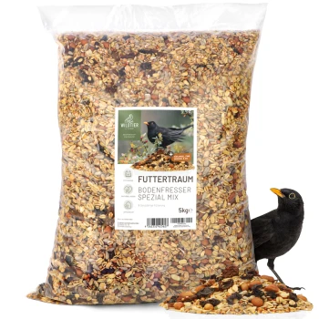 Futtertraum Amselfutter 5kg Ein 5 kg Beutel "Futtertraum Bodenfresser Spezial Mix" Vogelfutter mit einer Mischung aus Samen und Nüssen, mit einem Schwarzvogel daneben.