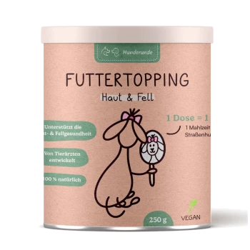 Zylindrischer Behälter mit der Aufschrift "Futtertopping Haut & Fell" mit einem Cartoon-Hund, Spiegel und Highlights wie "100% natürlich" und "Vegan."