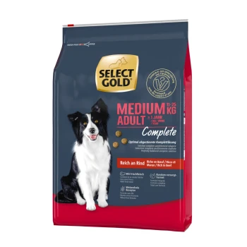 Hundetrockenfutterbeutel mit einem schwarz-weißen Hund auf der Vorderseite, beschriftet mit "SELECT GOLD MEDIUM ADULT Complete", reich an Rindfleisch.