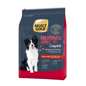 Hundetrockenfutterbeutel mit einem schwarz-weißen Hund auf der Vorderseite, beschriftet mit "SELECT GOLD MEDIUM ADULT Complete", reich an Rindfleisch.