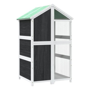 Outdoor-Holzhaustierhaus mit schwarzen Paneelen, weißem Rahmen, grünem Dach und Drahtgittergehege.