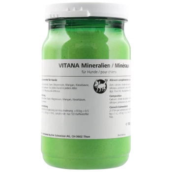 Grünes Glas mit VITANA Mineralien für Hunde, das Nährwertinformationen und Anwendungshinweise auf Deutsch und Französisch enthält.