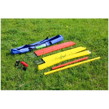 Hundesport-Agility-Stangen und Ausrüstung auf Gras ausgelegt mit einer blauen Tragetasche.