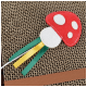 Rotes und weißes Filzpilz-Katzenspielzeug mit grünen und gelben Bändern auf einem Karton-Kratzbrett.
