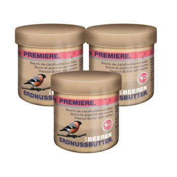 Drei Gläser Erdnussbutter mit Beeren, beschriftet mit "Premiere" in mehreren Sprachen, mit einer Vogelillustration auf der Vorderseite.