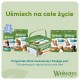 Przysmaki dentystyczne Whimzees dla psów — zielone saszetki i pojemnik z kształtami do żucia; widoczny tekst "Uśmiech na całe życie" oraz logo Whimzees.