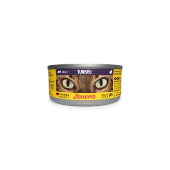 Acht Dosen Josera Katzenfutter mit der Aufschrift "Truthahn", die ein Katzenkopf mit grünen Augen und die Etiketten "Getreidefrei" und "Deutsche Qualität" zeigen.