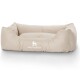 Beige Hundebett mit weichen, plüschigen Seiten und einer flachen Mitte, mit dem Logo "KNUFFELWUFF" deutlich angezeigt.