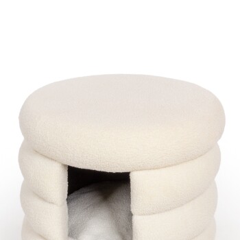 Ein gemütliches, rundes Haustierbett aus weichem cremefarbenem Stoff mit einem höhlenartigen Eingang, perfekt für kleine Haustiere zum Einkuscheln.