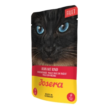 Nahaufnahme einer schwarzen Katze mit blauen Augen auf einer Dosenfutterverpackung, die mit "Huhn mit Rind" und "Josera" beschriftet ist, gekennzeichnet mit "Hergestellt in Deutschland."