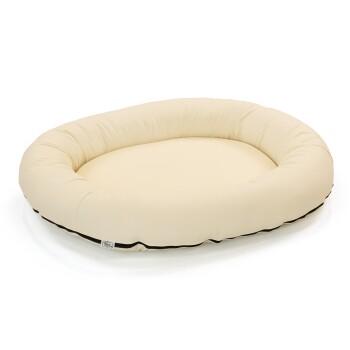 Cremefarbenes ovales Haustierbett mit einem plüschigen, gepolsterten Innenraum und einem schwarzen Rand, entworfen für Komfort und Entspannung.