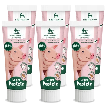 Sechs Knuffelwuff Leber Pastete Tuben mit Schweineillustrationen und Etiketten mit der Aufschrift "88% Schwein" und "Viel frisches Fleisch ohne Konservierungsstoffe."