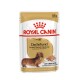 Royal Canin Adult Dachshund Hundefutterbeutel, 85g, mit einem Bild eines Dackels und Text, der die Unterstützung von Gelenken und Knochen hervorhebt.