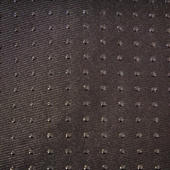 Nahaufnahme eines strukturierten schwarzen Stoffes mit kleinen, glänzenden Punkten, der einem Haustierzubehör oder Bettungsmaterial ähnelt.