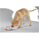 Yellow Labrador puppy sniffing pastel pink and blue fabric snuffle mat on gray background
