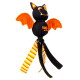 Black bat-shaped KONG Wubba toy with orange wings, smiling face and striped yellow/orange legs.