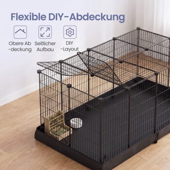 Schwarzer Draht-Auslauf für Haustiere auf einer Wanne mit Heufutterspender und Napf, darunter der Text 'Flexible DIY‑Abdeckung' und deutsche Symbolbezeichnungen.