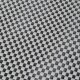 Close-up of a textured black and white pet mat featuring a checkerboard pattern, ideal for pet comfort and style.