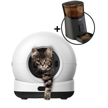 Weißes kugelförmiges Katzenklo mit getigertem Kätzchen, das mit der Pfote aus der vorderen Öffnung greift; Einblendung zeigt schwarzen automatischen Futterspender mit Trockenfutter.