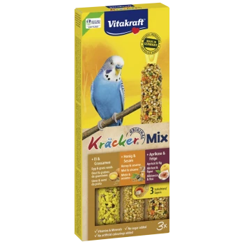 Vitakraft Kräcker Mix bird treat with egg, grass seeds, honey, sesame, apricot, and fig, featuring a blue budgerigar on yellow background.