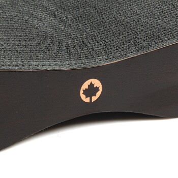 Nahaufnahme eines dunklen Holzkratzbretts für Haustiere mit einer strukturierten Oberfläche und einem kleinen kupferfarbenen Ahornblatt-Logo an der Seite.