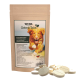 Ein Paket von TJURE Gelenk Tabs für Hunde, das eine braune Papiertüte mit einem grünen Etikett zeigt, umgeben von mehreren runden Tabletten.