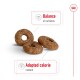 Three brown, donut-shaped pet treats are displayed, with text highlighting "Balance of nutrients" and "Adapted calorie content."