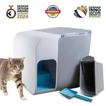 Eine graue und blaue Katzentoilette mit der Aufschrift "COLD DIGGER" und einer Schaufel, neben einer neugierigen getigerten Katze und Auszeichnungssymbolen für 2024 und 2023.