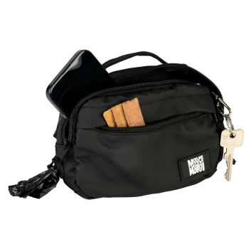 Schwarze Leckerli-Tasche für Haustiere mit Fronttasche, die Hundekekse, ein Smartphone, angehängte Schlüssel und einen Kotbeutelspender hält.