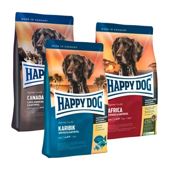 Drei Beutel Happy Dog-Hundefutter, beschriftet mit "Kanada", "Karibik" und "Afrika", mit einem Hundebild und Nährwertangaben.