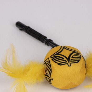Yellow feathered cat toy with black handle and black geometric patterns on the ball.