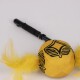 Yellow feathered cat toy with black handle and black geometric patterns on the ball.